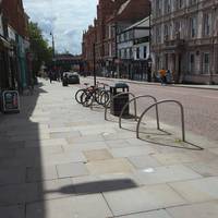 Turn right along the wide pavement past shops and cafes.